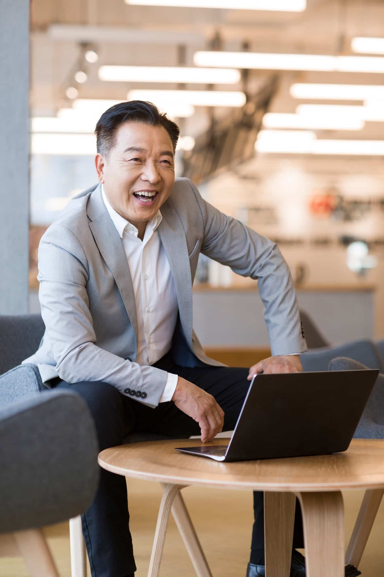 Confident businessman using laptop